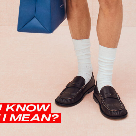 D'You Know What I Mean written across a photo of loafers with socks. background photo courtesy of louis vuitton.