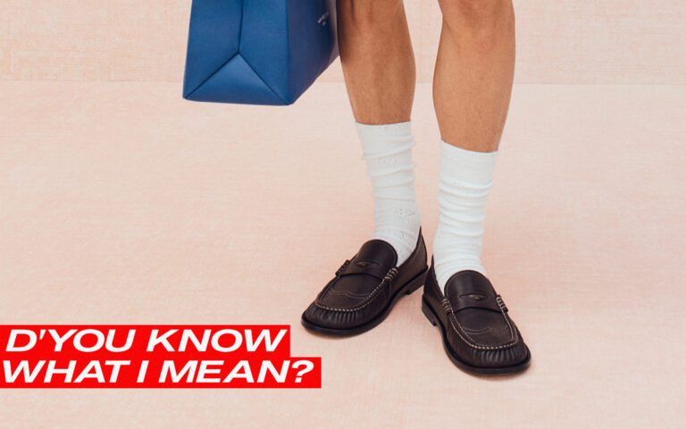 D'You Know What I Mean written across a photo of loafers with socks. background photo courtesy of louis vuitton.