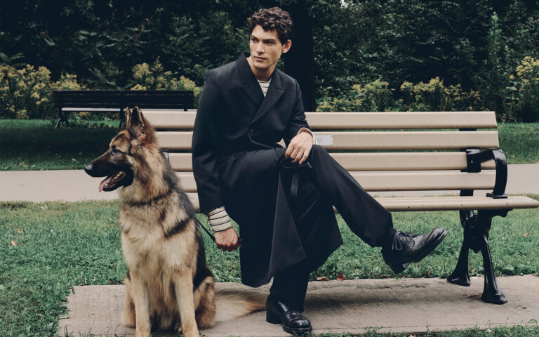 JACKET ($6,000), SHIRT ($3,650), PANTS ($2,650), SOCKS ($220), AND SHOES ($2,300) BY PRADA.